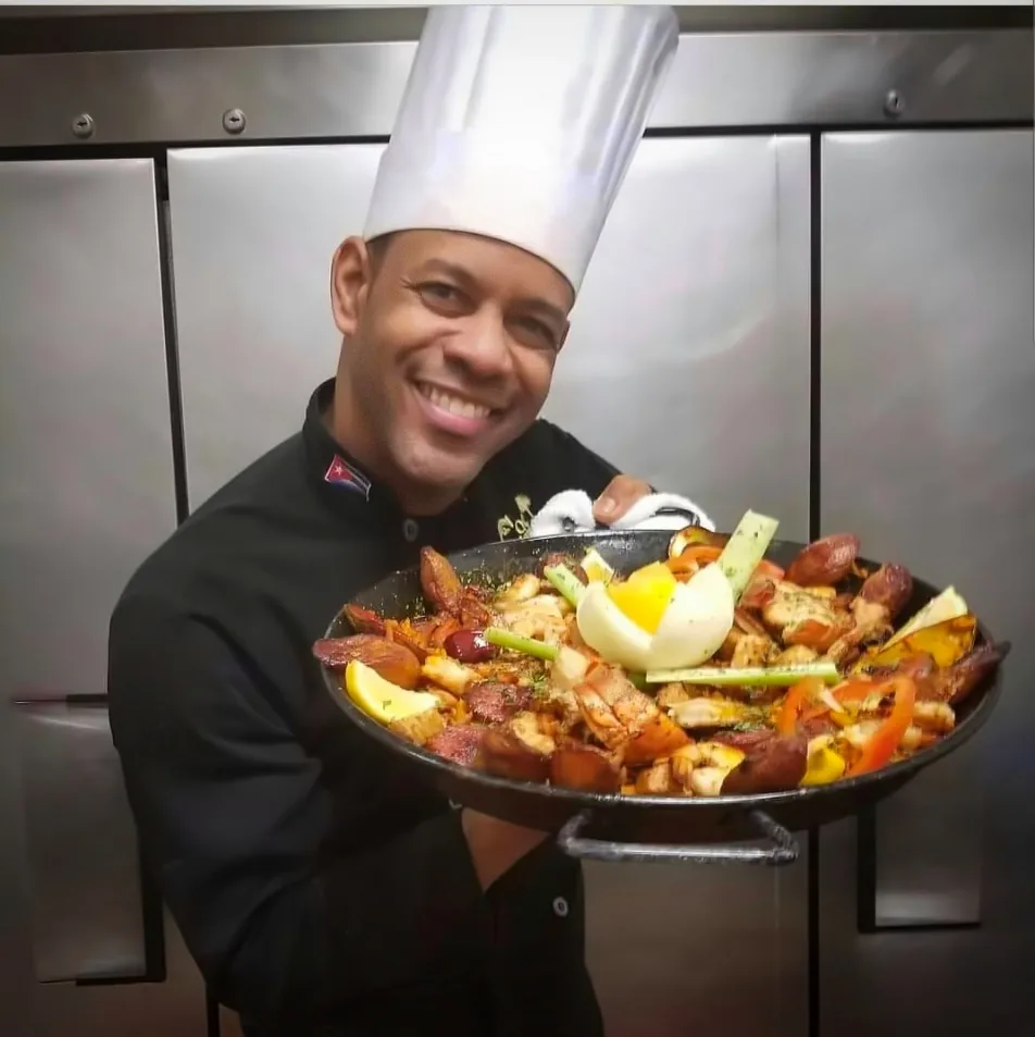 Chef Joel behind a giant seafood paella