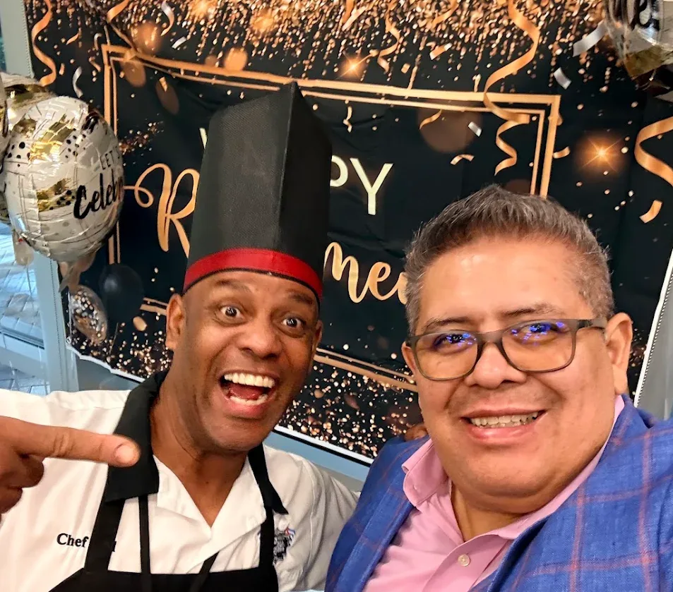 Felipe Ramirez taking a selfie with Chef Joel at a corporate celebration