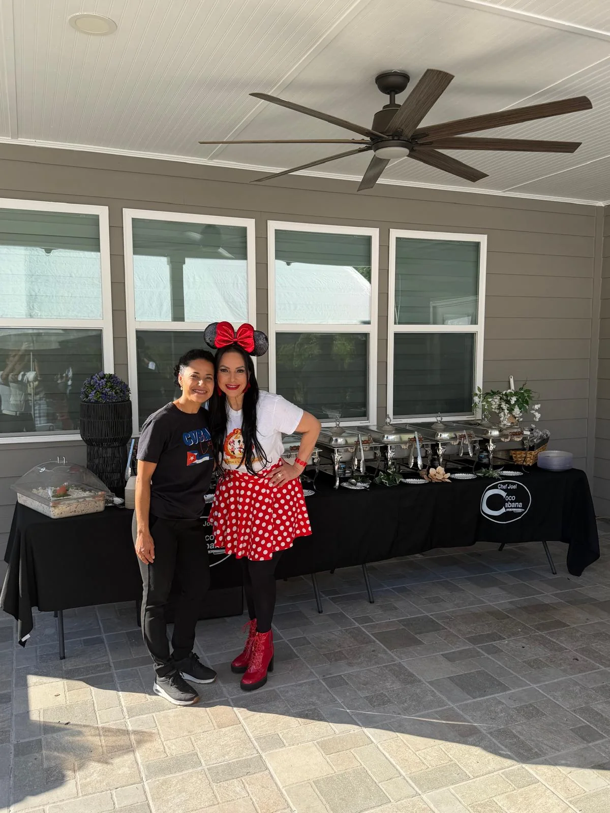 A guest in Minnie Mouse ears by the Cuban buffet at a birthday party