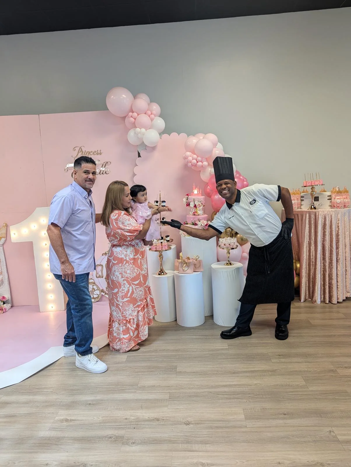 Chef Joel presenting dessert at a pink-themed baby shower