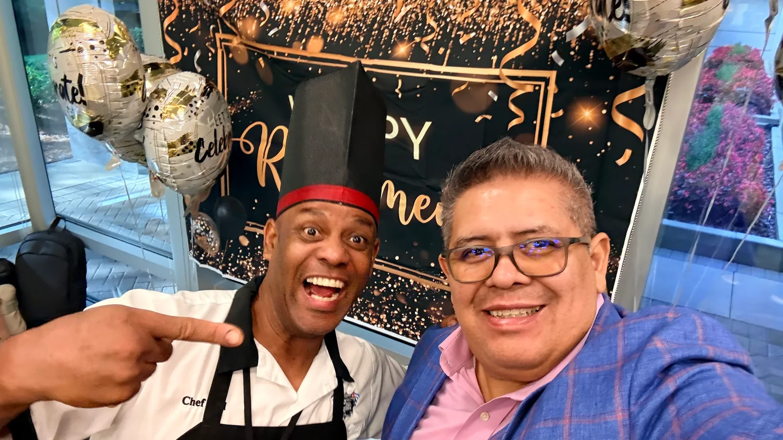 A birthday guest taking a selfie with Chef Joel