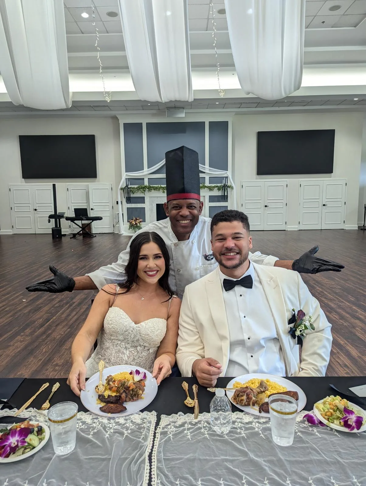 Newlyweds served their plated Cuban dinner at the head table