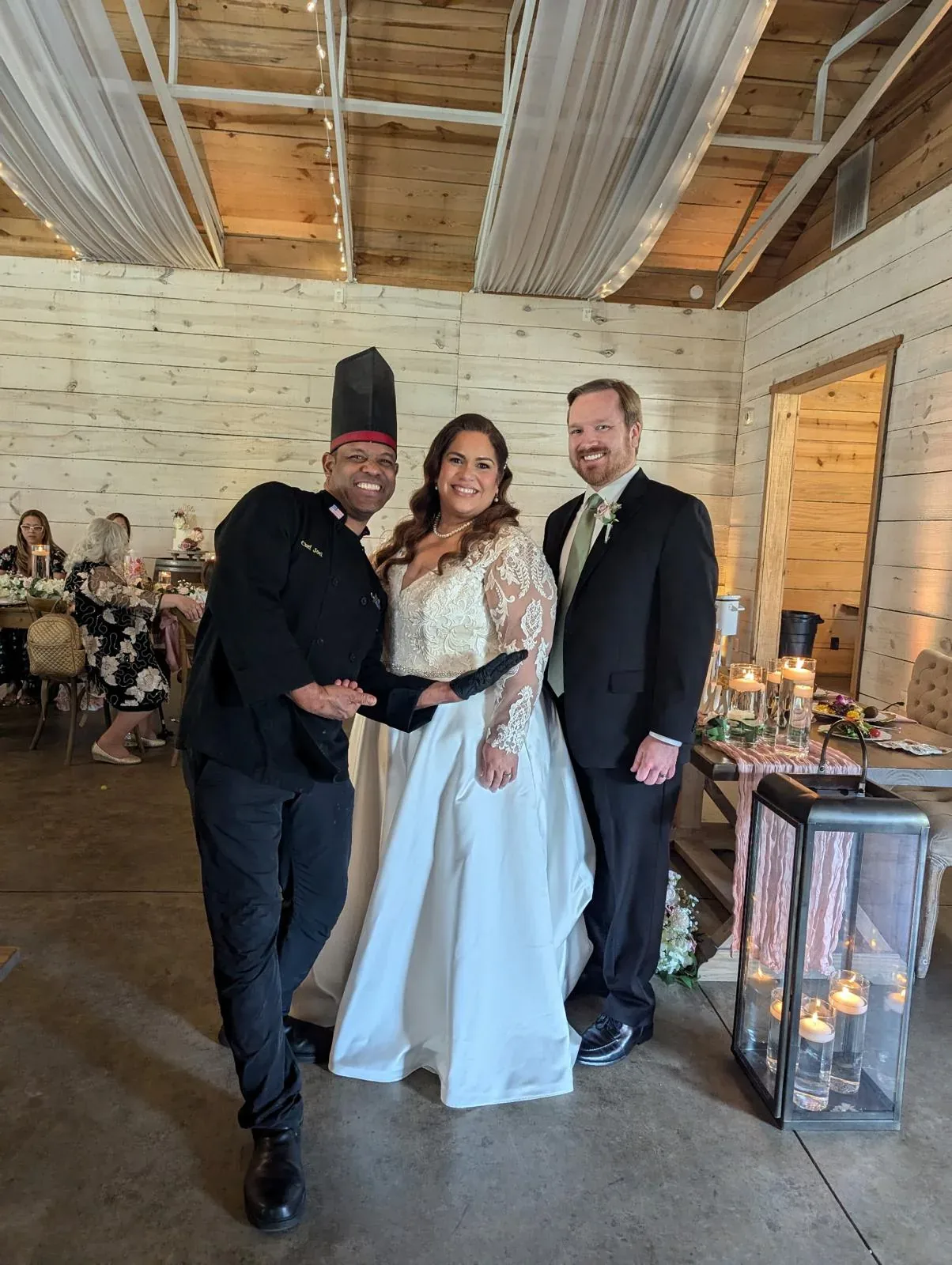 Chef Joel with a bride and groom at their reception